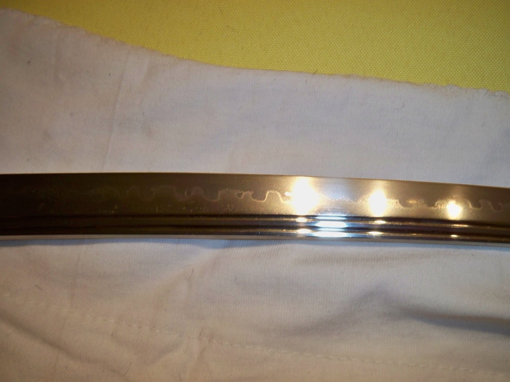 A katana blade showing the wavy hamon temper line